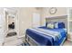 Bedroom featuring vaulted ceilings, gray furniture, and a blue comforter at 100 Lantana Dr, Locust Grove, GA 30248