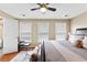 Spacious bedroom featuring a king-size bed with plush pillows and bright natural light from three windows at 100 Lantana Dr, Locust Grove, GA 30248