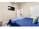 Bedroom showcasing a blue bedspread and a flat-screen TV at 100 Lantana Dr, Locust Grove, GA 30248