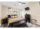 Cozy bedroom featuring a black bed frame, neutral wall color and a ceiling fan with light at 100 Lantana Dr, Locust Grove, GA 30248