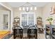 Dining area features modern lighting and convenient access to the kitchen at 100 Lantana Dr, Locust Grove, GA 30248