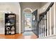 Inviting entryway showcasing hardwood floors, decor shelving and a view of the front yard through the open door at 100 Lantana Dr, Locust Grove, GA 30248