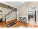 Inviting foyer featuring hardwood floors, a staircase, decorative accents, and an adjacent view into the kitchen at 100 Lantana Dr, Locust Grove, GA 30248