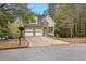 Charming two-story home featuring a stone facade, two-car garage, and well-maintained front yard at 100 Lantana Dr, Locust Grove, GA 30248