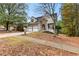 Charming two-story home with a stone facade, a well-manicured lawn, and a two-car garage at 100 Lantana Dr, Locust Grove, GA 30248