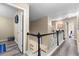 View of the second story hallway with wood floors and black and white railing, doors to rooms visible at 100 Lantana Dr, Locust Grove, GA 30248