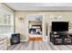 Comfortable living space offering an open doorway to main bedroom and neutral walls at 100 Lantana Dr, Locust Grove, GA 30248