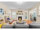 Bright living room with a fireplace, comfortable seating, and hardwood floors at 100 Lantana Dr, Locust Grove, GA 30248