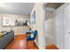 Open living area with hardwood floors and an adjacent kitchen area with gray cabinets at 100 Lantana Dr, Locust Grove, GA 30248