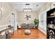Bright sitting room with hardwood flooring, neutral wall color, and views to the front yard at 100 Lantana Dr, Locust Grove, GA 30248