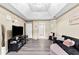 Cozy living room with a unique tray ceiling, a comfortable sofa, and ample space for relaxation at 100 Lantana Dr, Locust Grove, GA 30248