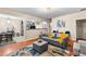 Open-concept living area featuring hardwood floors and flowing to the dining area and kitchen at 100 Lantana Dr, Locust Grove, GA 30248