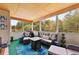 Comfortable screened-in patio area with outdoor furniture and wooded views at 100 Lantana Dr, Locust Grove, GA 30248