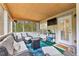 Relaxing screened-in patio featuring comfortable seating and a wooded view at 100 Lantana Dr, Locust Grove, GA 30248