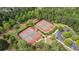 An aerial view of the community tennis courts with well-maintained courts and parking at 100 Lantana Dr, Locust Grove, GA 30248