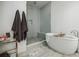 Luxurious bathroom featuring a freestanding tub, frameless glass shower, and modern design at 1076 Green St, Roswell, GA 30075