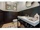 Stylish powder room with dark wood paneling, white vanity, and elegant decor at 1076 Green St, Roswell, GA 30075