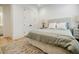 Cozy bedroom with a comfortable bed, soft lighting, and a view into the on-suite bathroom at 1076 Green St, Roswell, GA 30075