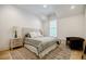Serene bedroom with vaulted ceiling, neutral tones, a cozy rug, and a comfortable seating area at 1076 Green St, Roswell, GA 30075