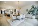 Bright and open dining room flows into kitchen, featuring modern chandelier and ample seating at 1076 Green St, Roswell, GA 30075