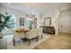 Stylish dining area with wood table, elegant chandelier, and ample natural light from windows at 1076 Green St, Roswell, GA 30075