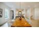 Bright dining room with a modern chandelier, long wooden table, and ample natural light at 1076 Green St, Roswell, GA 30075
