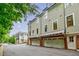 Townhomes feature a brick facade, multi-car garage, and traditional design at 1076 Green St, Roswell, GA 30075