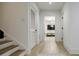 Bright hallway features wood floors, white trim, stairs, and an entry to a living room at 1076 Green St, Roswell, GA 30075