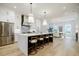 Spacious white kitchen with stainless steel appliances, large island, and pendant lighting at 1076 Green St, Roswell, GA 30075