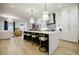 Open concept kitchen with quartz island, pendant lights and stainless appliances flowing into living space at 1076 Green St, Roswell, GA 30075