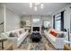 Spacious living room boasts stylish decor, a cozy fireplace, and hardwood floors at 1076 Green St, Roswell, GA 30075