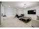 Living room features a large TV, sleeper, decoratice light fixture, and accent furniture at 1076 Green St, Roswell, GA 30075