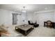 Large living room features a sliding door, modern chandelier, sofa, and decorative rug at 1076 Green St, Roswell, GA 30075