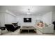 Modern living room features a decorative chandelier, a sofa, and a large TV at 1076 Green St, Roswell, GA 30075