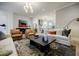 Open-concept living room featuring stylish furniture, art, and an open kitchen at 1076 Green St, Roswell, GA 30075