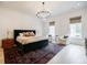 Elegant main bedroom with a luxurious bed, chandelier, and a large area rug at 1076 Green St, Roswell, GA 30075