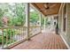 Relaxing covered front porch featuring brick flooring, ceiling fan, and white railing at 1076 Green St, Roswell, GA 30075