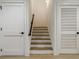 Staircase features wood stairs and white risers, adjacent to two doors at 1076 Green St, Roswell, GA 30075