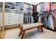 Well-organized walk-in closet with custom shelving, hanging space, and a comfortable bench at 1076 Green St, Roswell, GA 30075