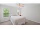 Bright bedroom with a ceiling fan, two windows, and neutral tones, creating a relaxing atmosphere at 1529 Shiloh Manor Ct, Marietta, GA 30066
