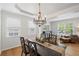 Elegant dining room featuring a large table, chandelier, and ample natural light at 1529 Shiloh Manor Ct, Marietta, GA 30066