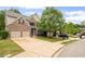 Suburban home with a long driveway, two car garage, and manicured lawn at 1529 Shiloh Manor Ct, Marietta, GA 30066