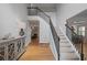 Bright foyer with hardwood floors, staircase with black railings, and stylish decor at 1529 Shiloh Manor Ct, Marietta, GA 30066