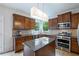 This kitchen features a center island and stainless steel appliances, creating a functional and modern cooking space at 1529 Shiloh Manor Ct, Marietta, GA 30066