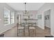 Inviting dining area with large windows, modern chandelier, and convenient access to the kitchen and living spaces at 345 Wellington Sw St, Atlanta, GA 30310