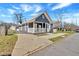 Charming home with a gray exterior, white trim, a covered porch, and a long driveway at 345 Wellington Sw St, Atlanta, GA 30310