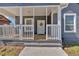 Charming front porch with white railings, and a cozy, inviting space to welcome guests and enjoy the outdoors at 345 Wellington Sw St, Atlanta, GA 30310
