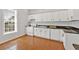 A clean and classic kitchen offers white cabinetry, granite countertops, and stainless dishwasher at 345 Wellington Sw St, Atlanta, GA 30310