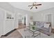 Bright living room with stylish furnishings, a decorative fireplace, and an open view to the dining and kitchen areas at 345 Wellington Sw St, Atlanta, GA 30310
