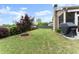 Picturesque backyard showcasing a lush green lawn, landscaping, and screened-in porch at 5920 Hart Way, Cumming, GA 30028